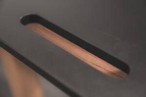 welding fixture table featuring flat, carbon steel surface with precision holes heavy-duty black frame, and locking red casters